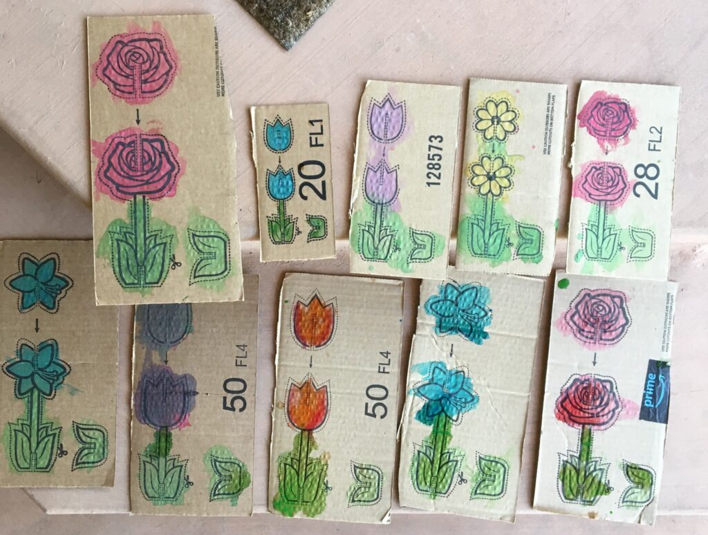 Hero image featuring a variety of flowers painted onto 2x5 sized cardboard pieces. The flowers are pictured with perforated lines to cut around them. The images are designed to fit with each other to make three dimensional flowers.